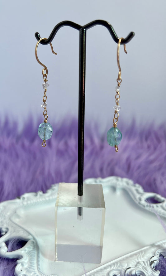 Handmade 14k gold-filled Aquamarine and Herkimer Diamond earrings displayed on a jewelry card, featuring delicate wire-wrapped details and natural gemstones.