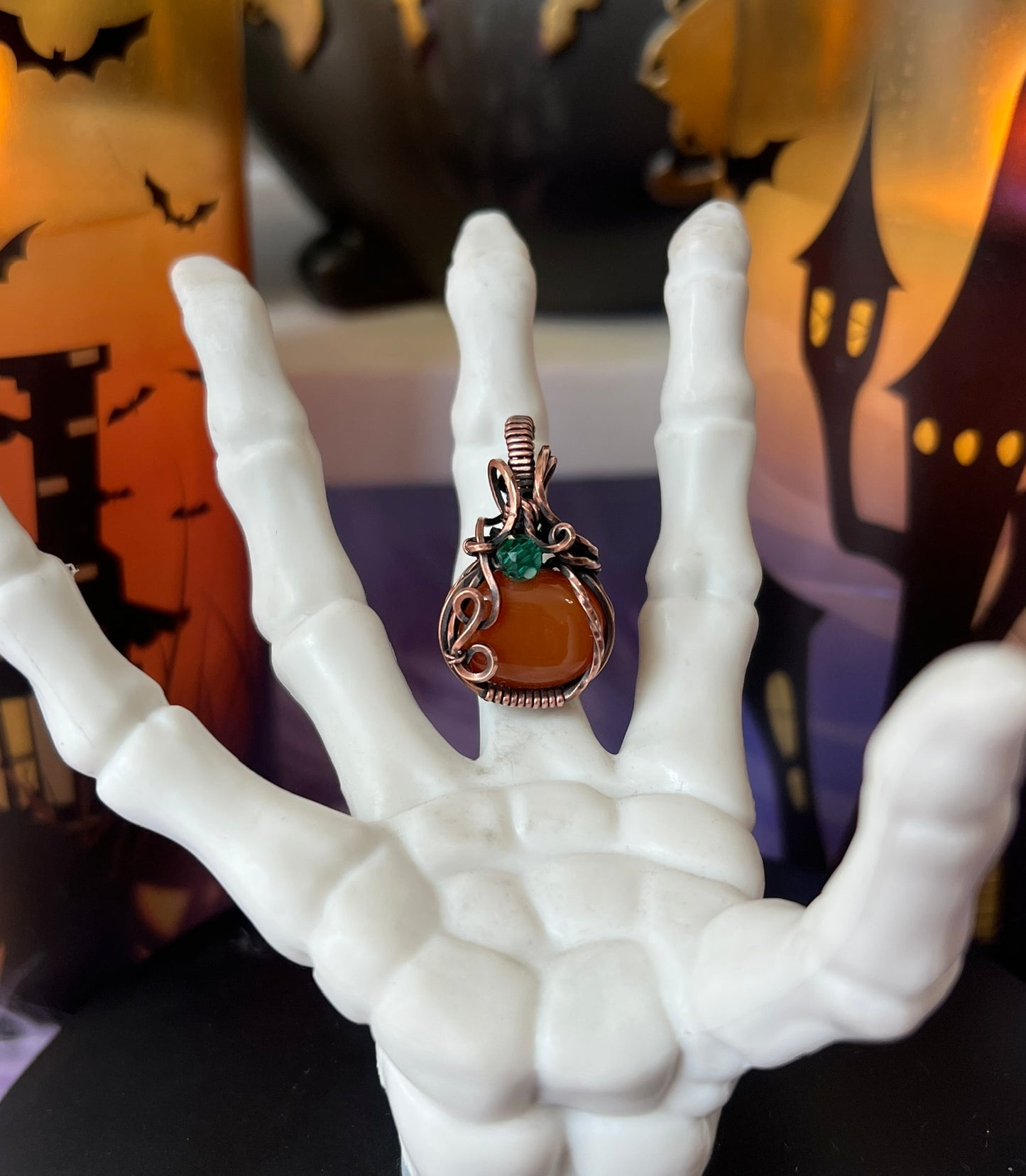 Handmade Carnelian pumpkin pendant with green crystal bead accent wrapped in copper – witchy Halloween necklace
