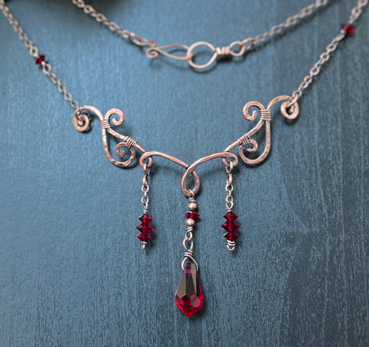 Handcrafted oxidized copper choker with garnet Swarovski crystals, perfect for celestial, mystical, and vintage-inspired looks.