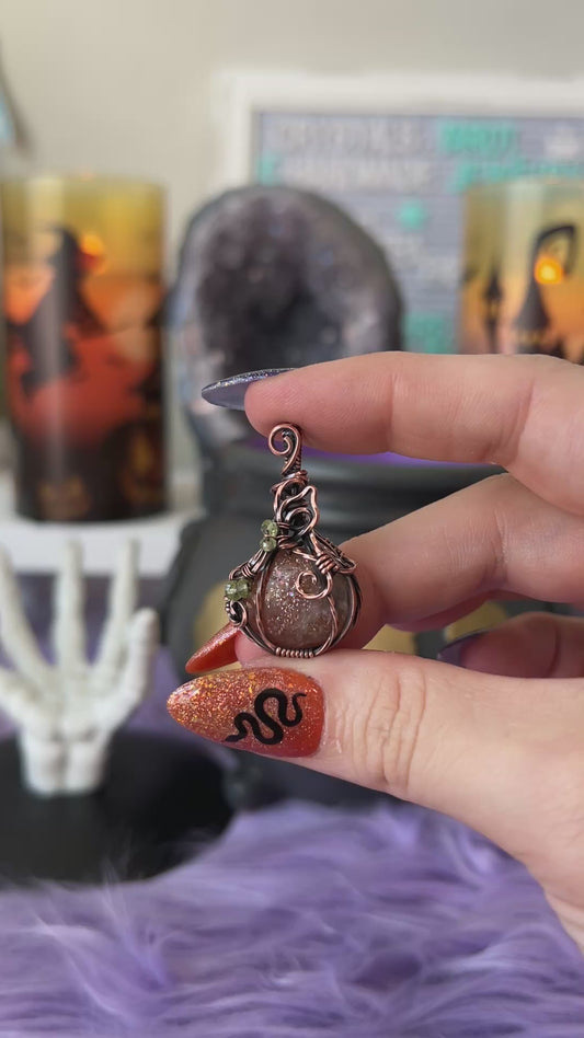 Handmade Sunstone pumpkin pendant with Peridot bead accents wrapped in copper wire – witchy Halloween necklace
