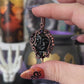 Handmade Black Onyx moon face pendant with Garnet accents and copper wire wrapping – witchy necklace for protection and power