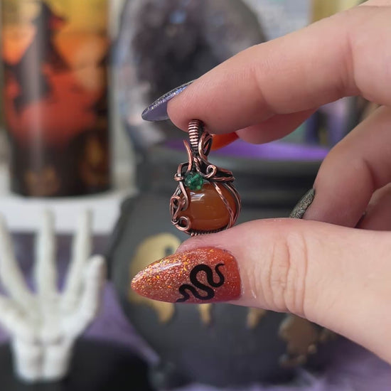 Handmade Carnelian pumpkin pendant with green crystal bead accent wrapped in copper – witchy Halloween necklace
