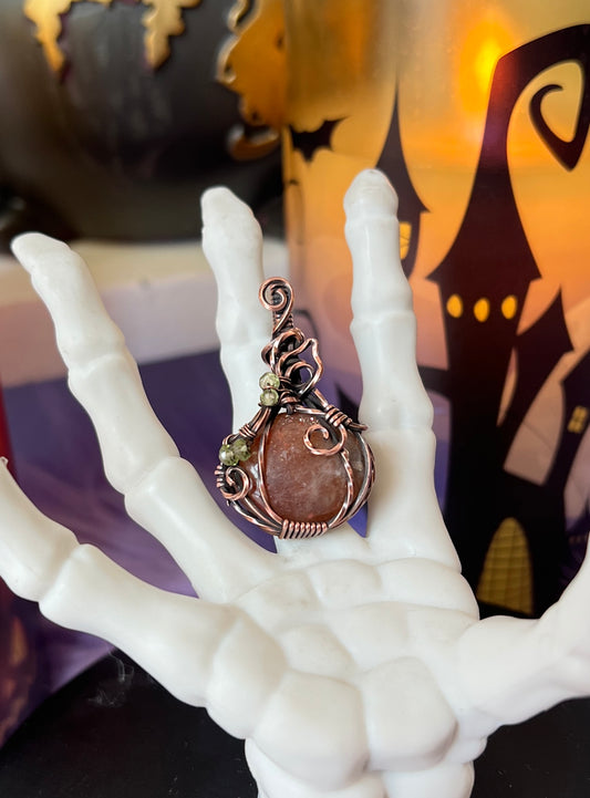 Handmade Sunstone pumpkin pendant with Peridot bead accents wrapped in copper wire – witchy Halloween necklace
